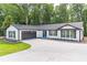 Newly built home with a modern white exterior, dark trim and a well-manicured lawn at 2265 Hillbriar Dr, Buford, GA 30518