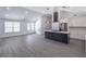 Spacious open kitchen featuring a kitchen island with a cooktop, stainless appliances, and modern lighting at 2265 Hillbriar Dr, Buford, GA 30518
