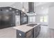 The kitchen has an island with a cooktop and a black accent wall at 2265 Hillbriar Dr, Buford, GA 30518