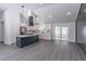 Bright kitchen with an island, modern lighting, stainless steel refrigerator, and sliding glass doors to the outside at 2265 Hillbriar Dr, Buford, GA 30518
