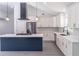 A close-up view of a kitchen island with a cooktop, marble countertops, and modern lighting at 2265 Hillbriar Dr, Buford, GA 30518