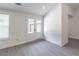 Bright living space with gray laminate flooring, white walls and white trim at 2265 Hillbriar Dr, Buford, GA 30518
