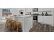 Bright kitchen features an island with seating and stainless steel appliances at 2348 Argento Cir, Dacula, GA 30019