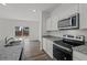Galley kitchen featuring granite countertops, stainless appliances and backyard access at 2348 Argento Cir, Dacula, GA 30019
