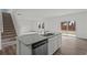 Open-concept space with eat-in kitchen, staircase and granite island counter with sink at 2348 Argento Cir, Dacula, GA 30019