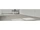 Spacious living room with gray carpet and transition to the kitchen and dining area, offering an open layout at 2348 Argento Cir, Dacula, GA 30019