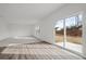 Bright living room featuring modern flooring, neutral paint, and sliding doors to the backyard at 2348 Argento Cir, Dacula, GA 30019