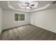 This bedroom features a ceiling fan and a window with a view at 3458 Natalie Ct, Loganville, GA 30052
