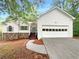 Charming one-story home with white siding, stone accents, and attached garage at 3458 Natalie Ct, Loganville, GA 30052