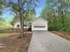 One-story home featuring white siding, stone accents, attached garage, and concrete driveway at 3458 Natalie Ct, Loganville, GA 30052