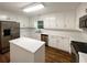 Updated kitchen featuring white cabinets, stainless appliances, and functional island at 3458 Natalie Ct, Loganville, GA 30052