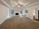 Spacious living room featuring a white fireplace and tray ceiling at 3458 Natalie Ct, Loganville, GA 30052