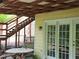 Relaxing covered patio with outdoor seating, stairs to backyard, and glass doors to let in natural light at 363 Weatherstone Ln, Marietta, GA 30068