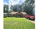Charming single-story home featuring a lush green lawn, complementing the cozy architecture and inviting curb appeal at 107 Honeysuckle Ln, Stockbridge, GA 30281
