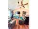Comfortable living room with hardwood floors, a ceiling fan, and plenty of natural light at 107 Honeysuckle Ln, Stockbridge, GA 30281