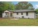 A beautiful backyard featuring a fountain, covered porch, and freshly mulched flower beds at 1340 Juneau Ct, Tucker, GA 30084