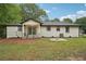 Well-kept backyard with a white-bricked house, fountain, and inviting covered porch at 1340 Juneau Ct, Tucker, GA 30084