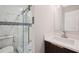 Modern bathroom with glass shower doors, stone floors, and a vanity at 1340 Juneau Ct, Tucker, GA 30084