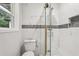 Bathroom featuring a glass shower with gold trim and stone floors at 1340 Juneau Ct, Tucker, GA 30084