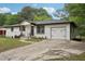 A nicely renovated one-story home featuring white brick, dark roof, and fresh landscaping at 1340 Juneau Ct, Tucker, GA 30084