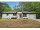 Charming, renovated single-story home with white brick and siding, complemented by a well-manicured front lawn at 1340 Juneau Ct, Tucker, GA 30084
