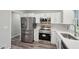 Bright kitchen featuring stainless steel appliances, white cabinets, and modern finishes at 1340 Juneau Ct, Tucker, GA 30084