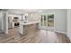 Open kitchen featuring stainless steel appliances, white cabinets, and a breakfast bar with backyard views at 1340 Juneau Ct, Tucker, GA 30084