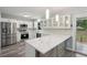 Modern kitchen featuring stainless appliances, white cabinets and an island with stone countertop and wooden accents at 1340 Juneau Ct, Tucker, GA 30084