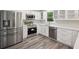 Beautiful kitchen with stainless steel appliances, white cabinets and hardwood floors at 1340 Juneau Ct, Tucker, GA 30084