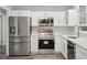 Modern kitchen featuring stainless steel appliances and bright white cabinetry at 1340 Juneau Ct, Tucker, GA 30084
