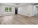 Bright living room with wood-look flooring, ceiling fan, and large window allowing for ample natural light at 1340 Juneau Ct, Tucker, GA 30084