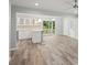 Open concept living room featuring wood-look flooring, with an island and view of the backyard at 1340 Juneau Ct, Tucker, GA 30084