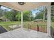 A covered porch with a view of the spacious backyard and mature trees at 1340 Juneau Ct, Tucker, GA 30084