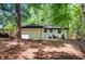 Charming backyard featuring the rear of the home and new fence at 1678 Capistrana Pl, Decatur, GA 30032