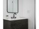 Modern bathroom features a black vanity, unique cabinet design, and sleek black faucet at 1678 Capistrana Pl, Decatur, GA 30032