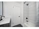 Bright bathroom featuring a modern vanity, toilet, and tiled shower with black fixtures at 1678 Capistrana Pl, Decatur, GA 30032