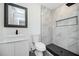 Modern bathroom with stylish vanity, toilet, and a tiled shower with a bench at 1678 Capistrana Pl, Decatur, GA 30032