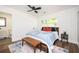 Relaxing bedroom with a queen size bed, bench, wood floors, and shiplap accent wall at 1678 Capistrana Pl, Decatur, GA 30032