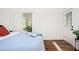 Bedroom showcasing a queen bed, bench, and brick wall with access to a backyard at 1678 Capistrana Pl, Decatur, GA 30032