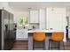 Bright kitchen features an island with seating, stainless appliances, and pendant lighting at 1678 Capistrana Pl, Decatur, GA 30032