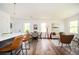 Living room and dining area featuring hardwood floors, modern decor, and plenty of natural light at 1678 Capistrana Pl, Decatur, GA 30032