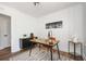 Office with wood floors, white paneled walls, city art, and modern black accents at 1678 Capistrana Pl, Decatur, GA 30032