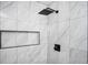 Close up of a modern tiled shower with black fixtures and a built-in niche at 1678 Capistrana Pl, Decatur, GA 30032