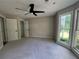 Spacious bedroom with neutral tones, a ceiling fan, and ample natural light from the windows at 3050 Camden Way, Alpharetta, GA 30005