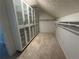 Walk-in closet with ample storage featuring custom built in shelves and modern glass doors at 3050 Camden Way, Alpharetta, GA 30005