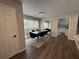 A clean and well-lit dining room features a large window, long table, and mirrored wall decor at 3050 Camden Way, Alpharetta, GA 30005