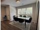 A sleek dining room featuring dark table and chairs, with natural light from the oversized windows at 3050 Camden Way, Alpharetta, GA 30005