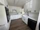 A modern kitchen with white cabinets, black hardware, white countertops, and stainless steel appliances at 3050 Camden Way, Alpharetta, GA 30005
