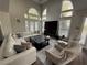 Bright living room with high ceilings and oversized windows, features a fireplace and dark floors at 3050 Camden Way, Alpharetta, GA 30005
