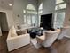 Bright living room with high ceilings and oversized windows, features a fireplace and dark floors at 3050 Camden Way, Alpharetta, GA 30005